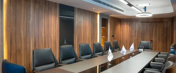 Elegant meeting space featuring comfortable black leather chairs and contemporary lighting.