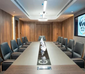 Luxurious conference room in Riyadh with comfortable seating and digital display for meetings.