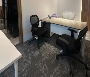 Comfortable seating with ergonomic office chairs and a sleek desk in a professional workspace.