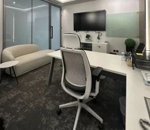 Bright, functional office with sleek furniture and tech setup in Riyadh.