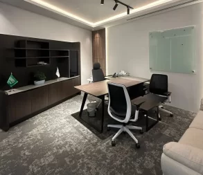 Elegant workspace with desks, chairs, and decorative touches.