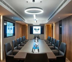 Premium meeting room in Riyadh with a modern boardroom table, presentation screen, and professional setup at WTC Riyadh