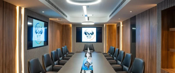Premium meeting room in Riyadh with a modern boardroom table, presentation screen, and professional setup at WTC Riyadh