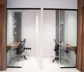 Premium waiting area at WTC Riyadh with elegant chairs and a modern accent wall.