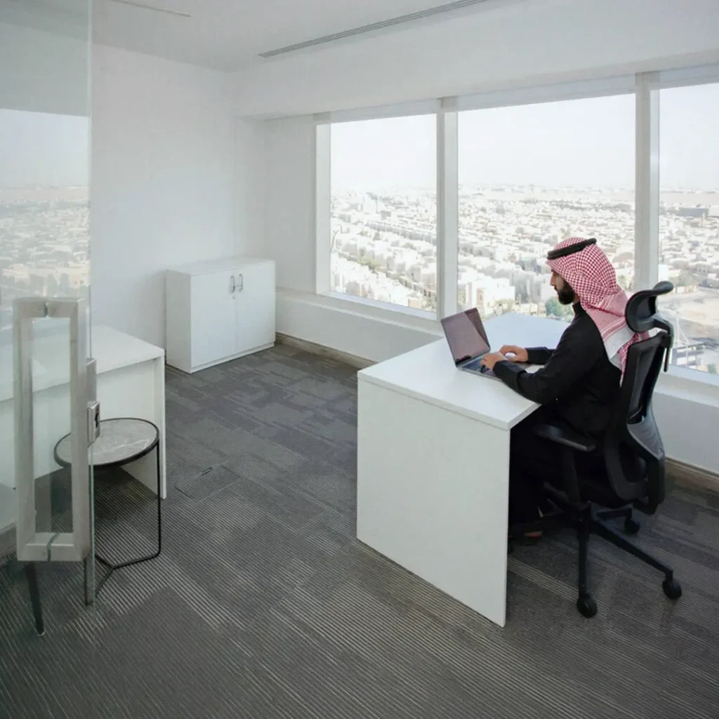 Man sitting in a clean white office space