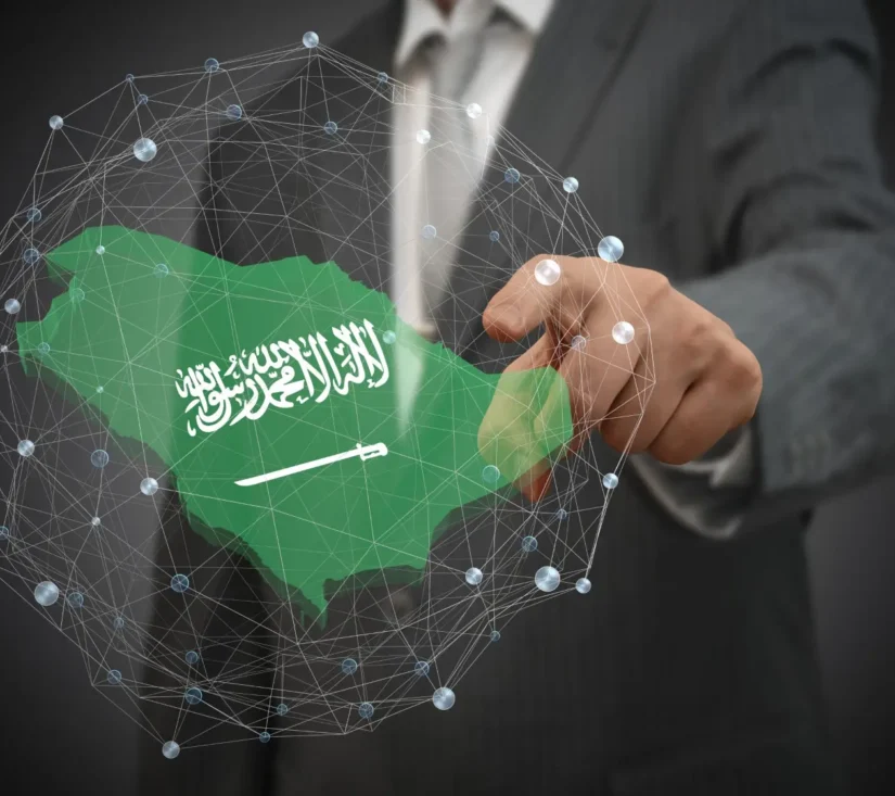 Close-up of a hand pointing to a map of Saudi Arabia