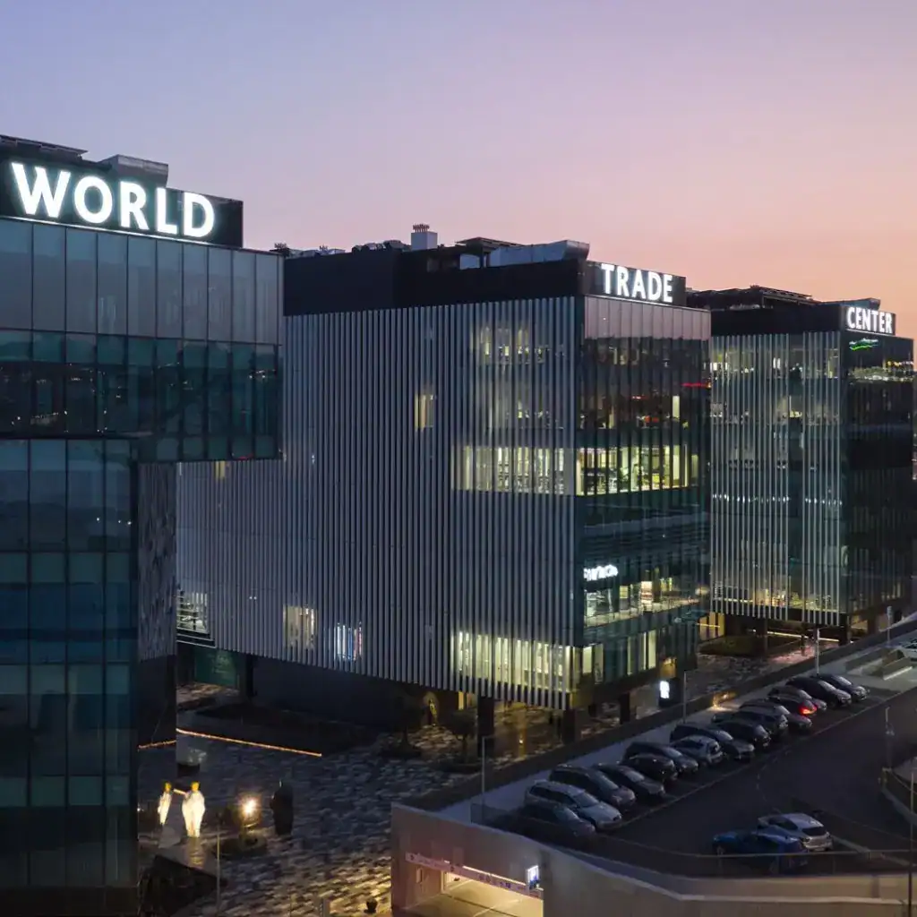 Modern office buildings at World Trade Center Riyadh with glass facades and signage.